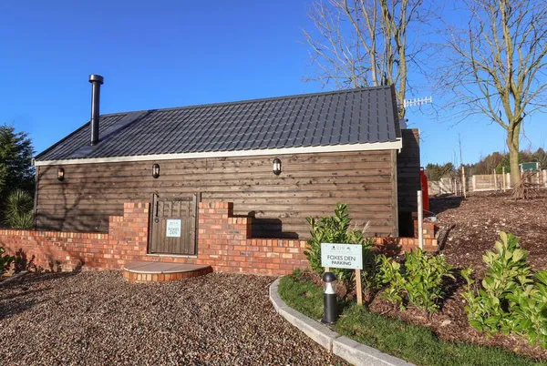 Foxes Den barn conversion front view with brick and timber cladding