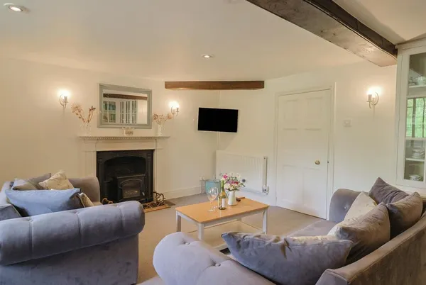 Garden View living room with inglenook fireplace and exposed beams