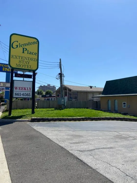 Sign for a gas station next to a street