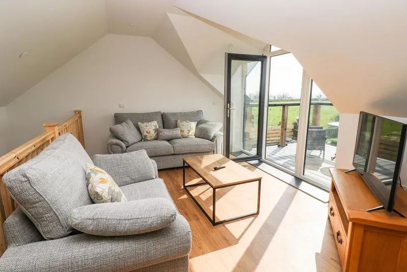 Glowty Brynbedw mezzanine lounge with full-height glazing