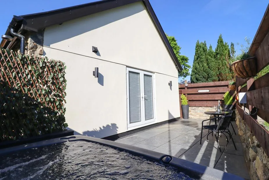 Glyndwr cottage exterior with private hot tub patio