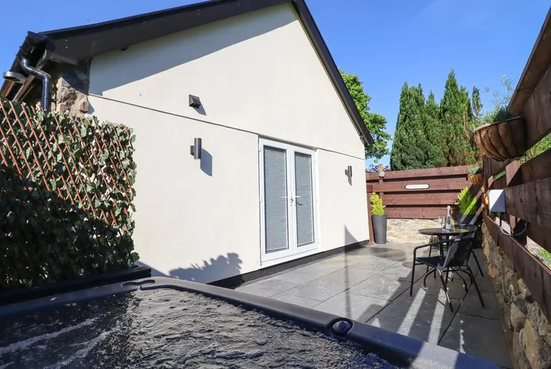 Glyndwr cottage exterior with private hot tub patio