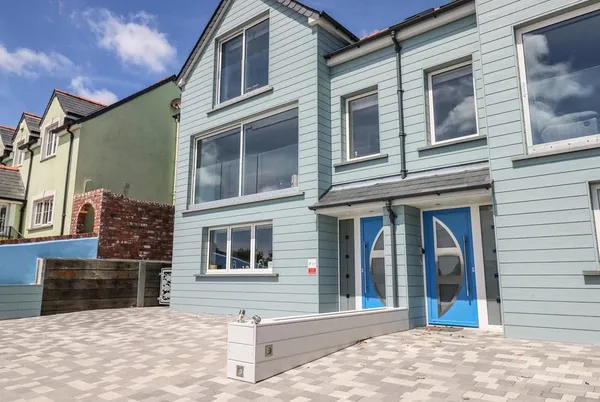 Harmon Vale coastal house exterior with large sea-view windows
