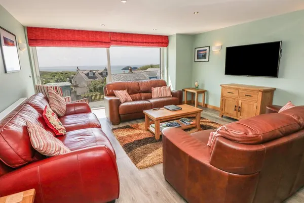 Harmon Vale living room with leather sofas and sea views
