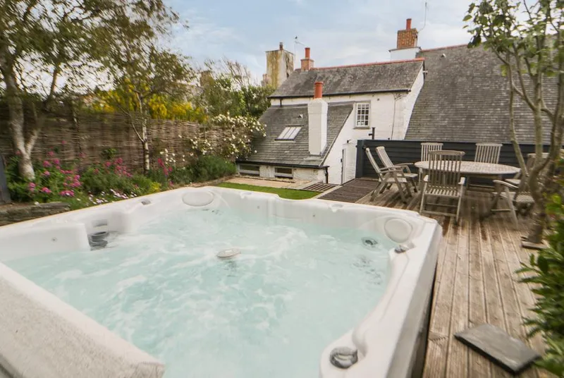 Great Western Farmhouse hot tub and decking beside the house