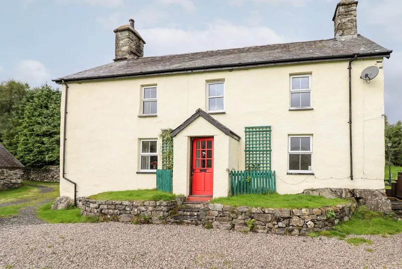 Gwengraig farmhouse exterior with red front door