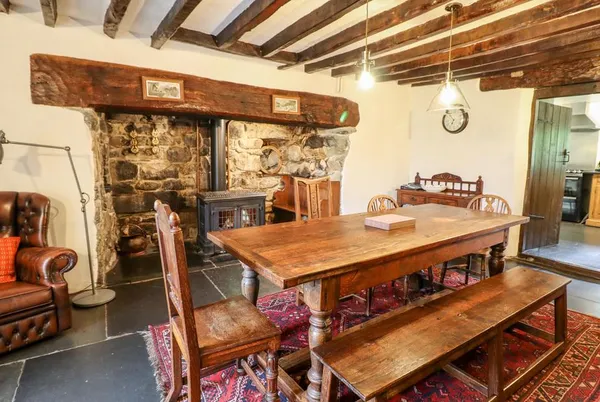 Gwengraig dining room with stone fireplace