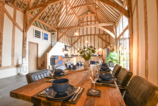 Halcyon Barn oak dining table set beneath soaring barn vaulting