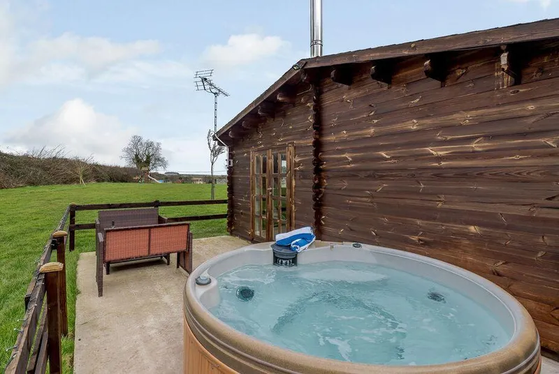 Halfmoon Wood bubbling hot tub beside the lodge