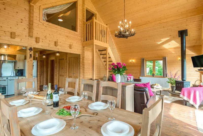 Hampton Lodge dining and living area under timber ceiling