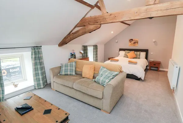 Hawthorn Cottage open-plan mezzanine with exposed beams and vaulted ceiling