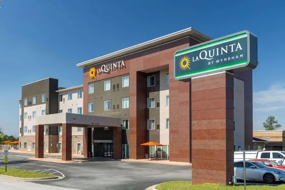 Hotel building with a sign in front of it