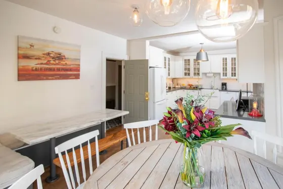 Vase of flowers on a wooden table in a kitchen