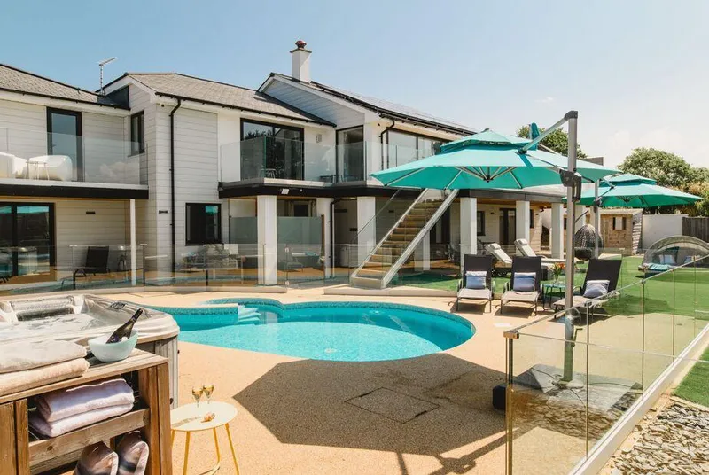 Heron House Newquay pool terraces and house in one wide view