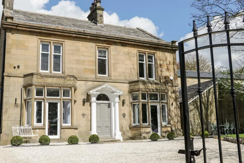 Herriots House grand stone entrance through wrought iron gate