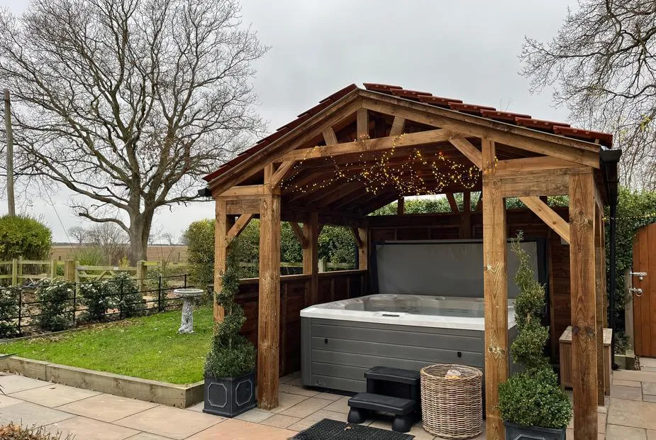High House hot tub under oak gazebo with fairy lights