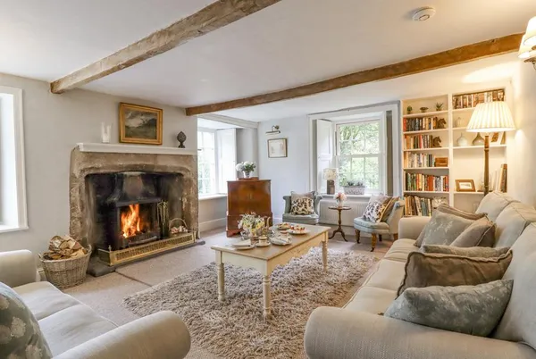 Hilltop House living room with roaring open fire and exposed beams