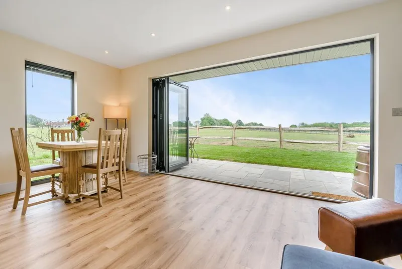 Hillview open-plan living area with bi-fold doors to countryside