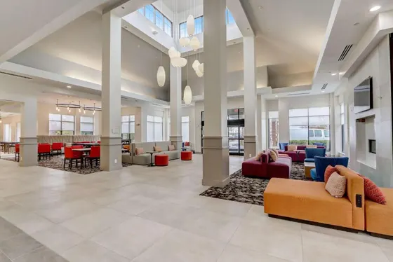 Lobby with orange benches and a fireplace