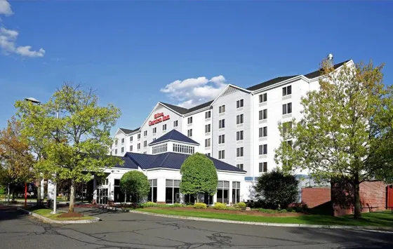 White hotel building with a blue roof