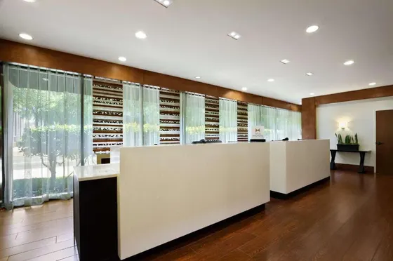 Library with a row of shelves of wine bottles