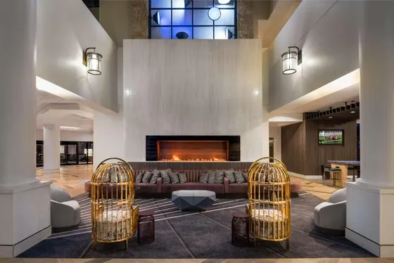 Lobby lounge with a tiled fireplace and maroon sofa