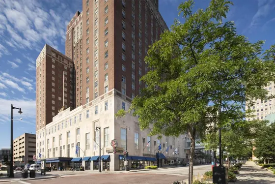 Tall building on a city street with a tree