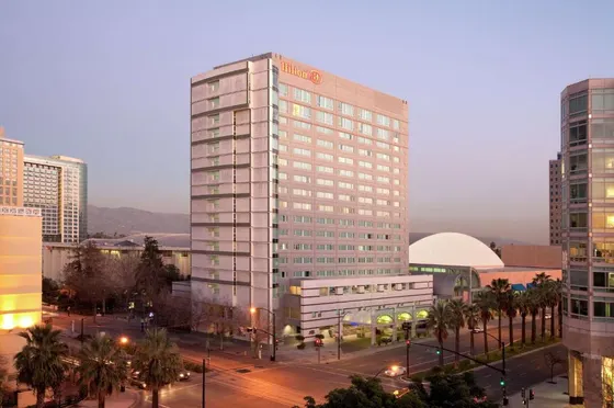 Tall white building in the middle of a city