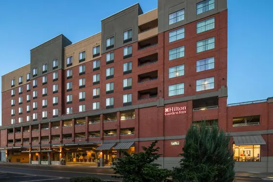 Large red brick building with a hotel