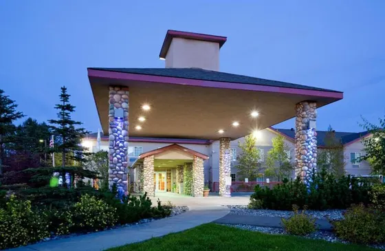 Home with a lit up front yard at night