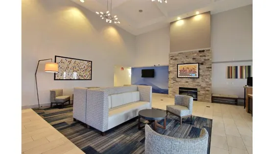 Room with a bed and chairs and a fireplace