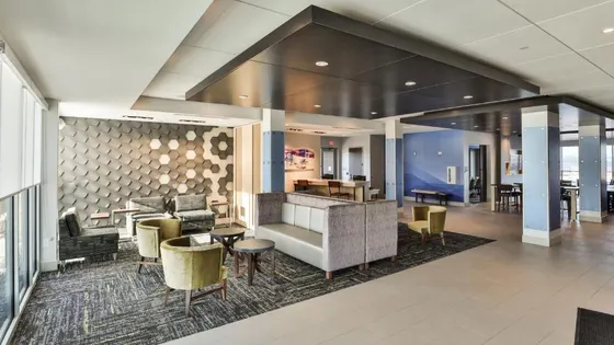 Lobby of a hotel with chairs and tables
