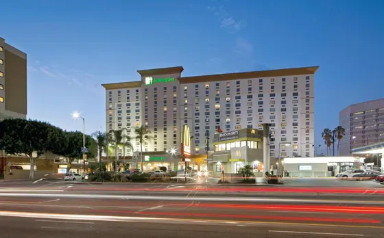 Large hotel building on a city street at night