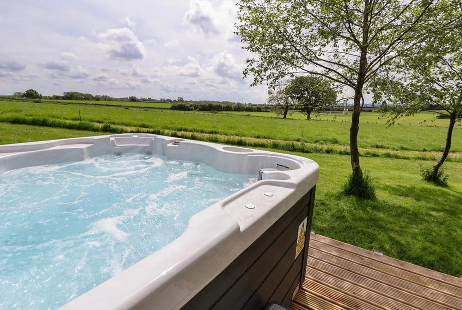 Holmside hot tub filled with water above the fields