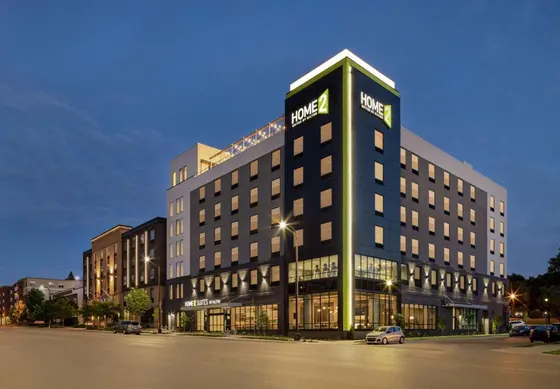 Corner hotel at dusk with a green stripe