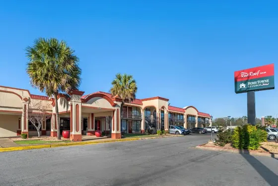 Street view of a hotel with palm trees