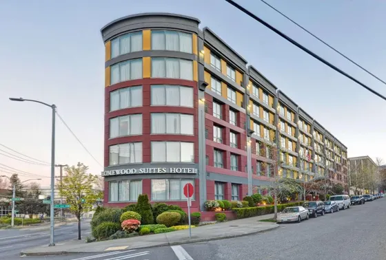 Red building on a street with cars parked outside