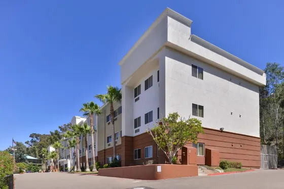 Building on a street with palm trees
