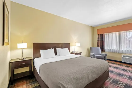 Hotel room with a large bed and a chair