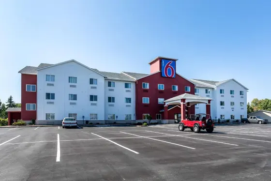 Red and white Motel 6 with a covered entrance