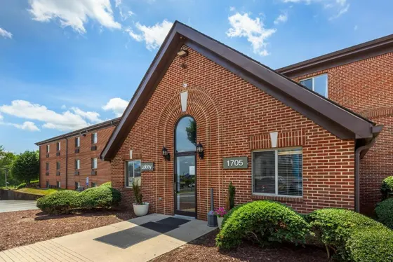 Brick building with bushes in front of it