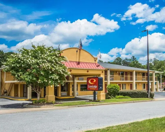 Yellow building with a sign in front of it