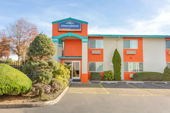 Hotel with a parking lot in front of it