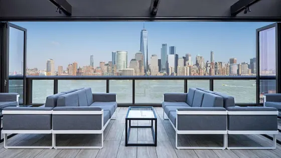 Living room with couches and a view of a city