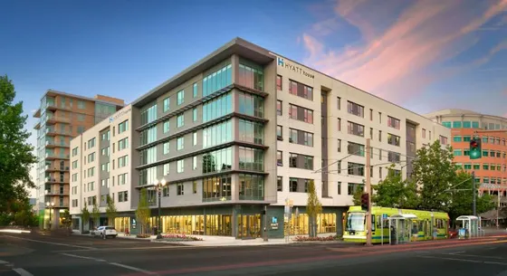 Building on the corner of a street with a bus