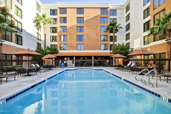 Outdoor swimming pool with tables and chairs and a building