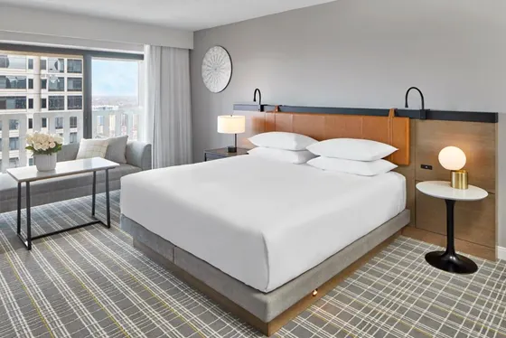 Bedroom with a large white bed and a couch