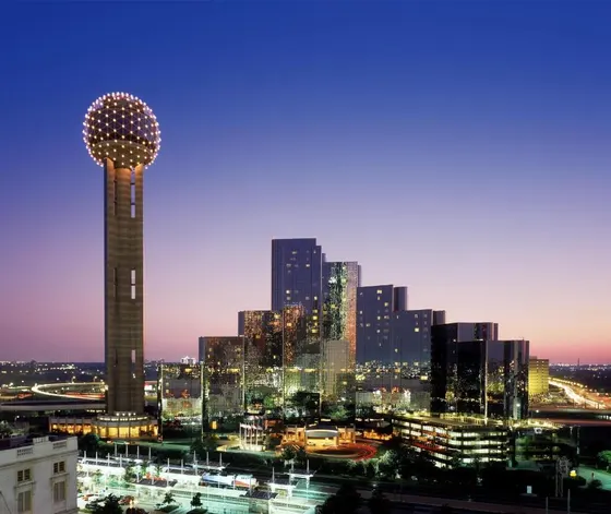 Reunion Tower and glass skyscrapers at dusk