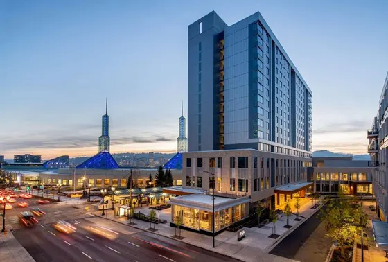 Tall glass building in a city with a street