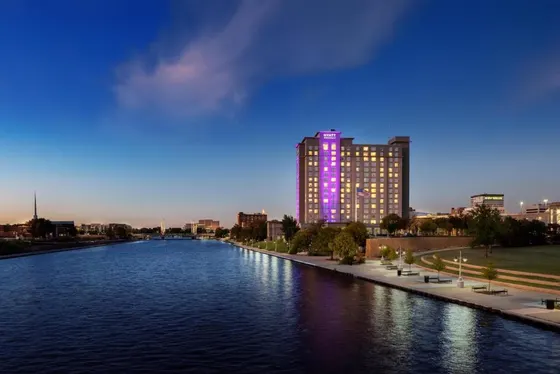 River with a building with purple lights on it